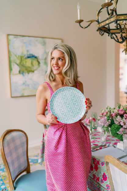 Ivy Manor slate blue china plate with white leaf motif, held by a woman in a pink dress on Tampa Home & Garden Store
