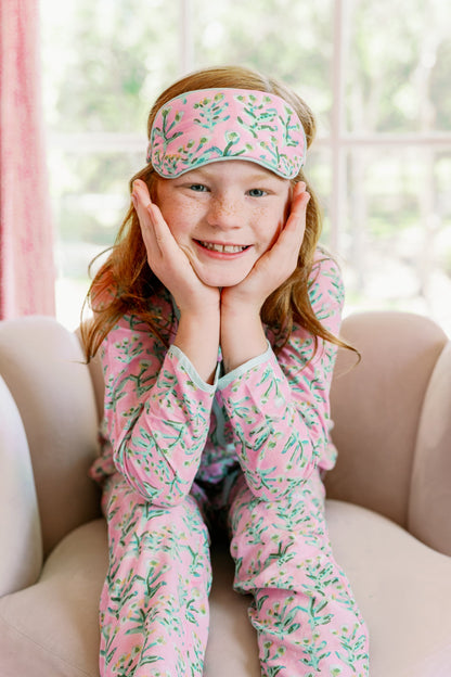 Mini Sydney Pajama Tulip Pink; child in pink floral pajamas with sleep mask, smiling on Tampa Home & Garden Store