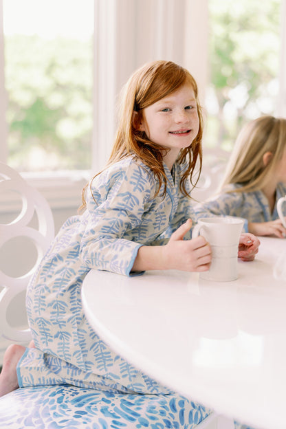 Mini Trellis Pajama blue set with long-sleeve top and pants, red-haired girl at a white table holding a mug on Tampa Home & Garden Store