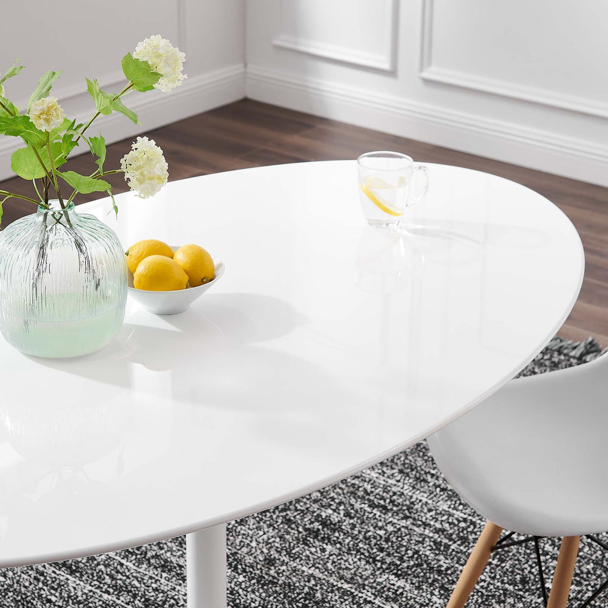Lippa Oval Wood Dining Table in white finish with lemon centerpiece and glass vase on Tampa Home & Garden Store