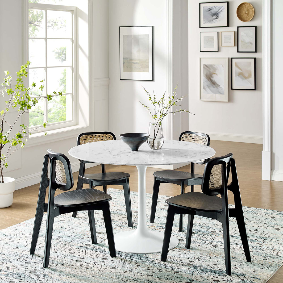 Lippa 48in round faux marble dining table with white pedestal base and black caned-back chairs on Tampa Home & Garden Store