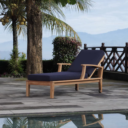 Marina teak outdoor chaise pair with navy cushions on a wooden poolside deck on Tampa Home & Garden Store