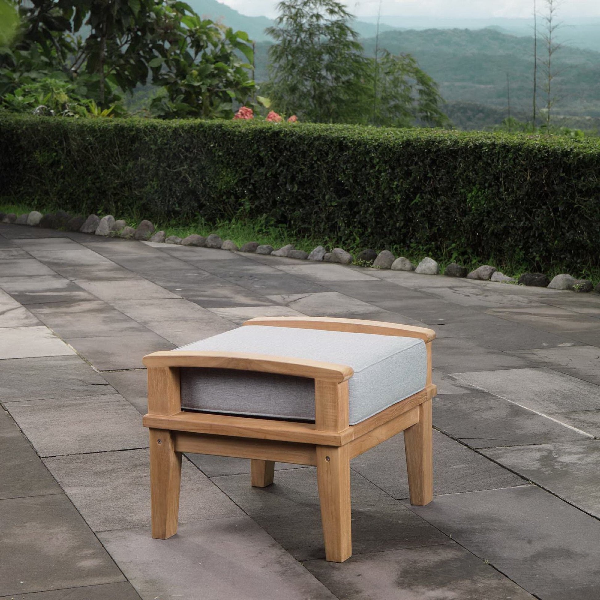 Marina Outdoor Patio Teak Ottoman pair with light gray cushions on a stone patio on Tampa Home & Garden Store