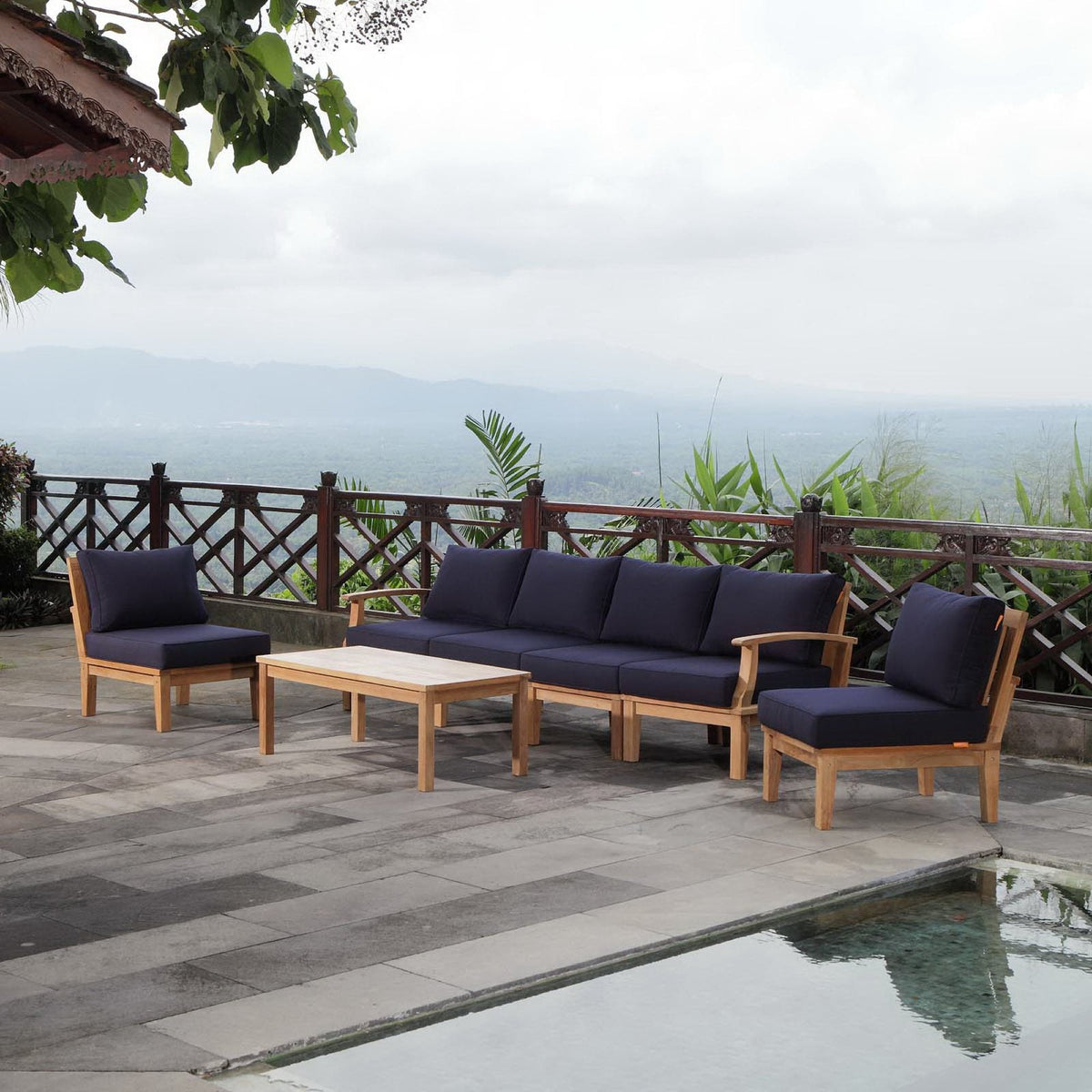 Marina 7-Piece Outdoor Teak Sofa Set with navy cushions on a patio on Tampa Home & Garden Store