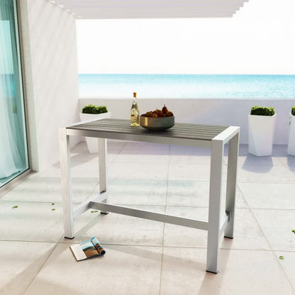 Shore Outdoor Patio Aluminum Rectangle Bar Table in silver-gray on a sunny patio with sea view on Tampa Home & Garden Store