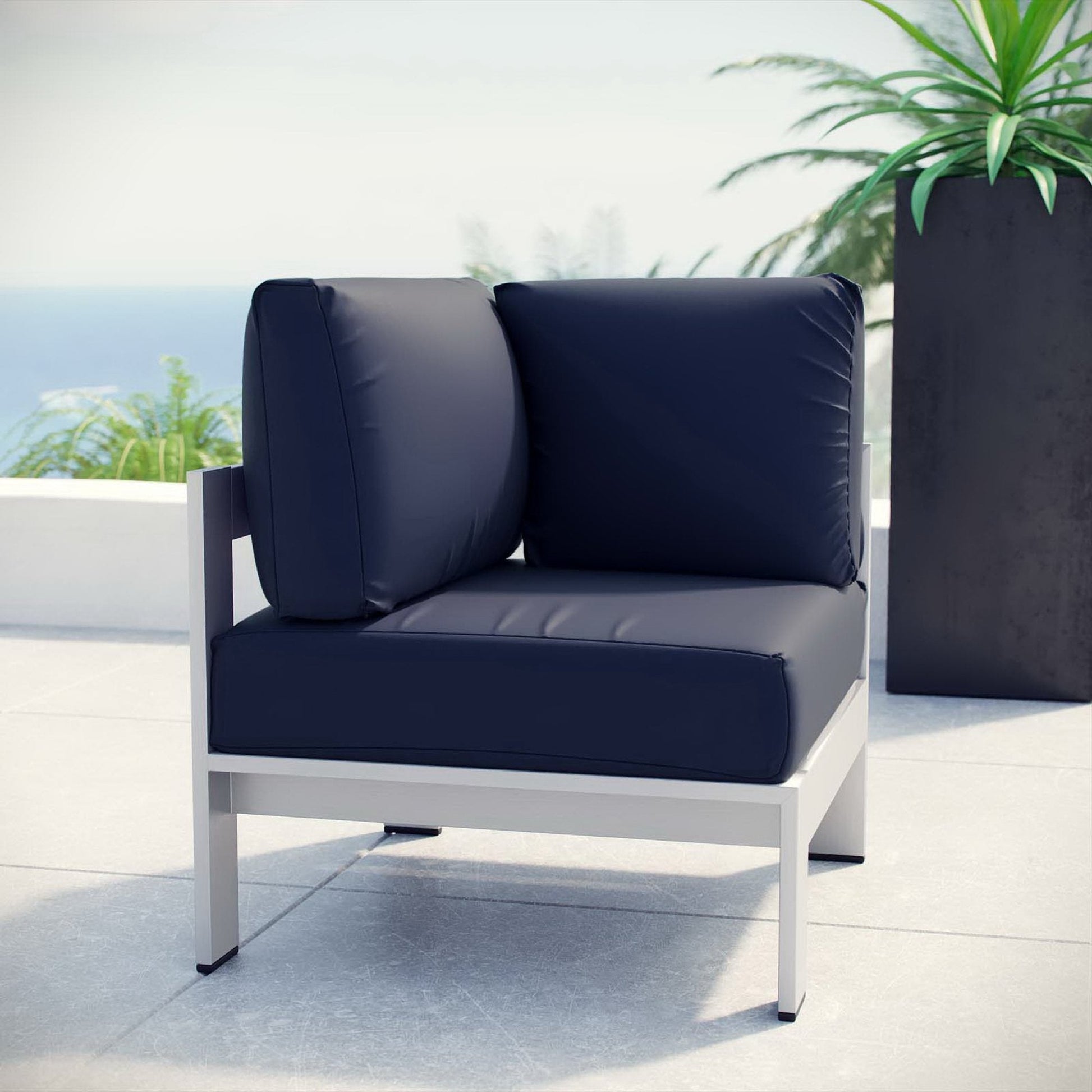 Shore outdoor patio aluminum corner sofa with navy cushions and white frame on Tampa Home & Garden Store