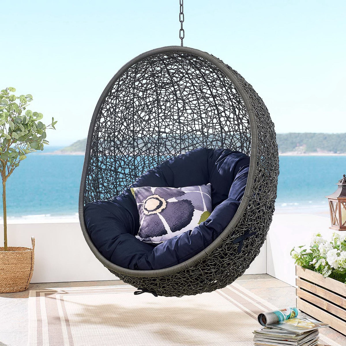 Hide Outdoor Patio Swing Chair by HouseOfZazla black woven egg chair with navy cushions on Tampa Home & Garden Store