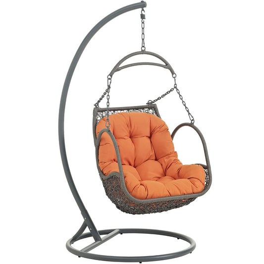 Arbor outdoor patio wood swing chair with orange cushion hanging from curved gray metal stand on Tampa Home & Garden Store