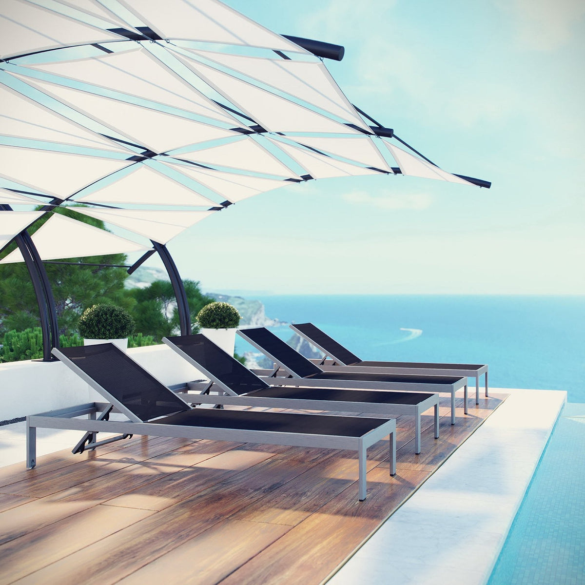 Shore outdoor aluminum chaise set of 4 by Modway with dark woven seats on a deck by the sea on Tampa Home & Garden Store