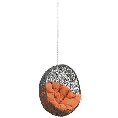 Outdoor hanging wicker chair with orange cushions, chain suspension for patio on Tampa Home & Garden Store