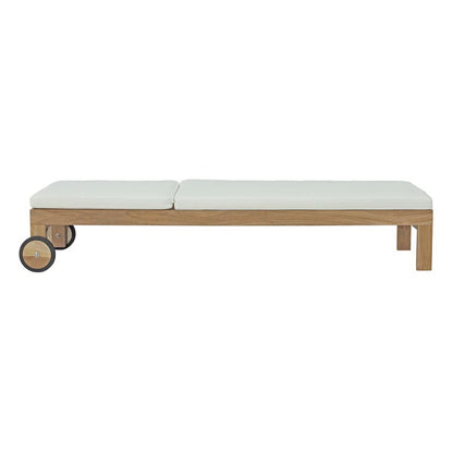 Upland outdoor teak chaise lounge with white cushions on a natural wood frame with wheels on Tampa Home & Garden Store