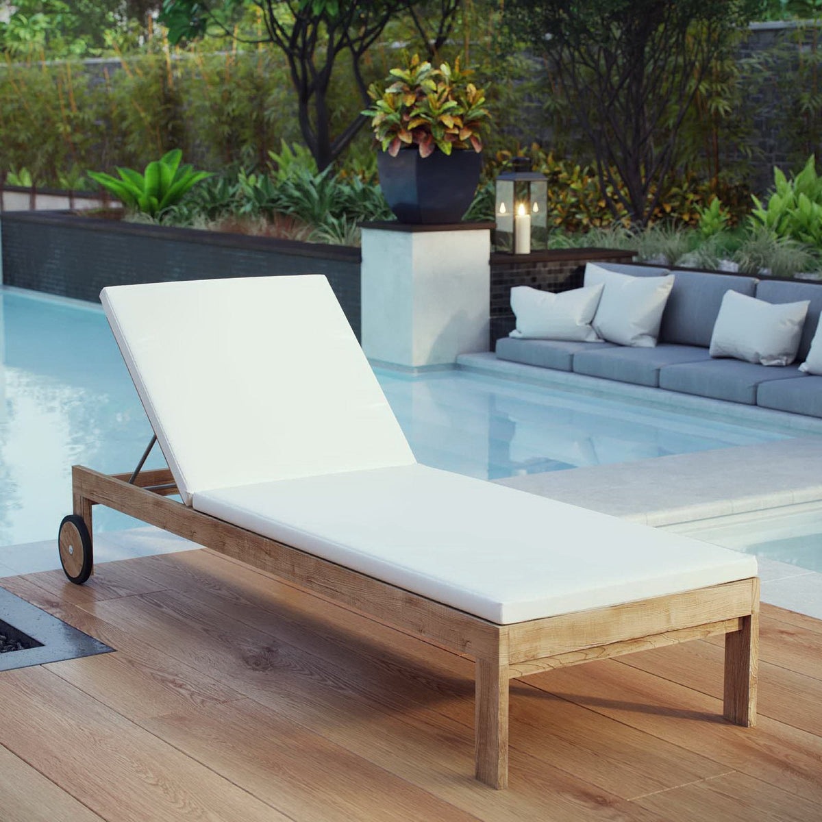 Upland outdoor teak chaise by Modway with white cushions on a wooden poolside deck on Tampa Home & Garden Store