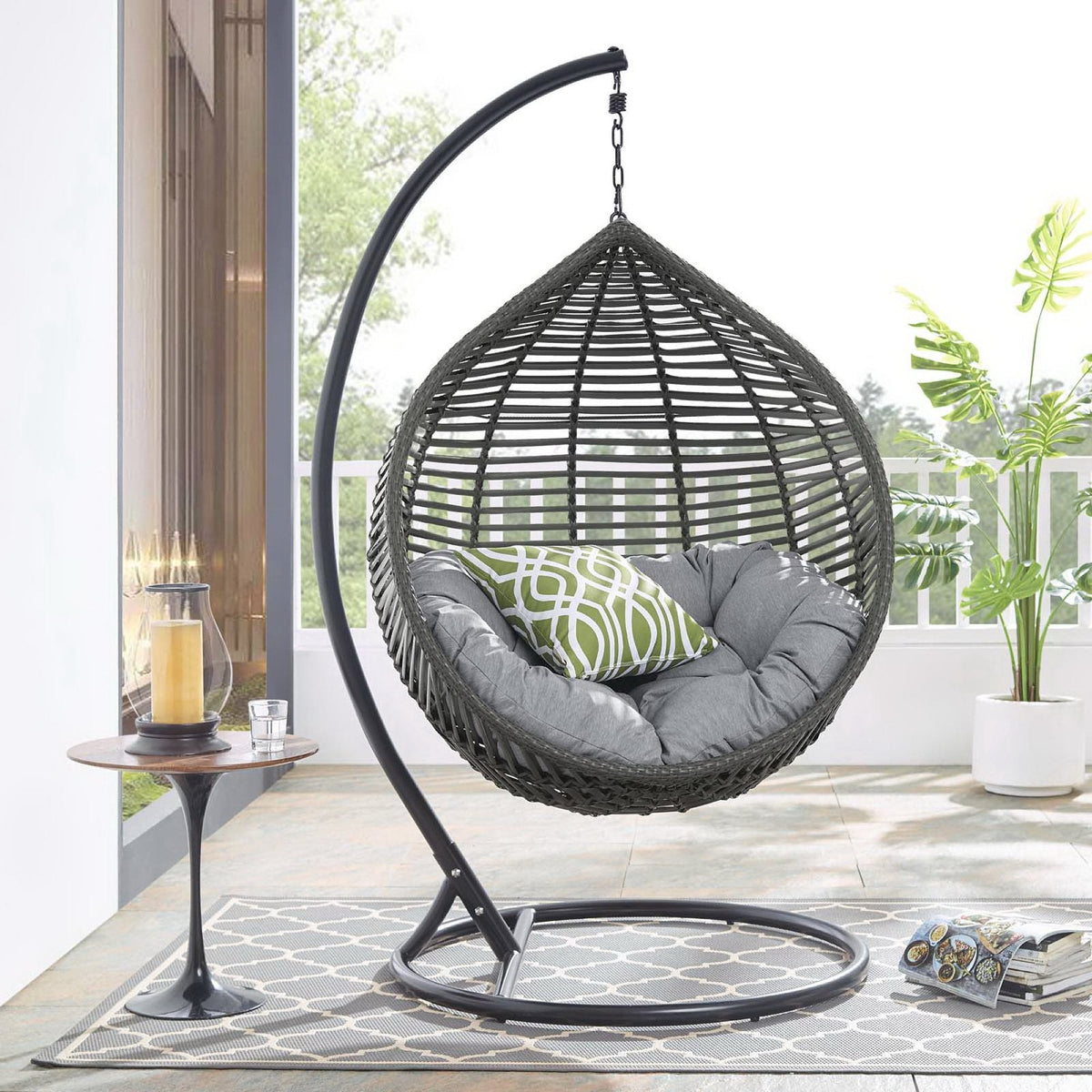 Garner teardrop outdoor swing chair in gray wicker with gray cushions on a curved black stand on Tampa Home & Garden Store