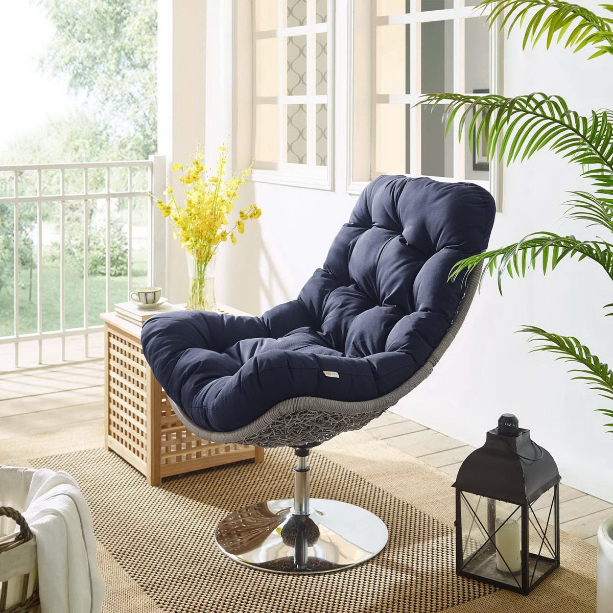 Brighton wicker rattan outdoor swivel lounge chair with navy cushions on balcony setting on Tampa Home & Garden Store