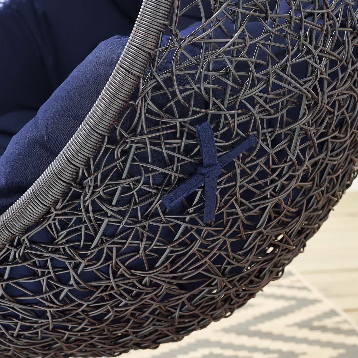 Encase Sunbrella outdoor lounge chair in dark woven wicker with navy cushion close-up on Tampa Home & Garden Store