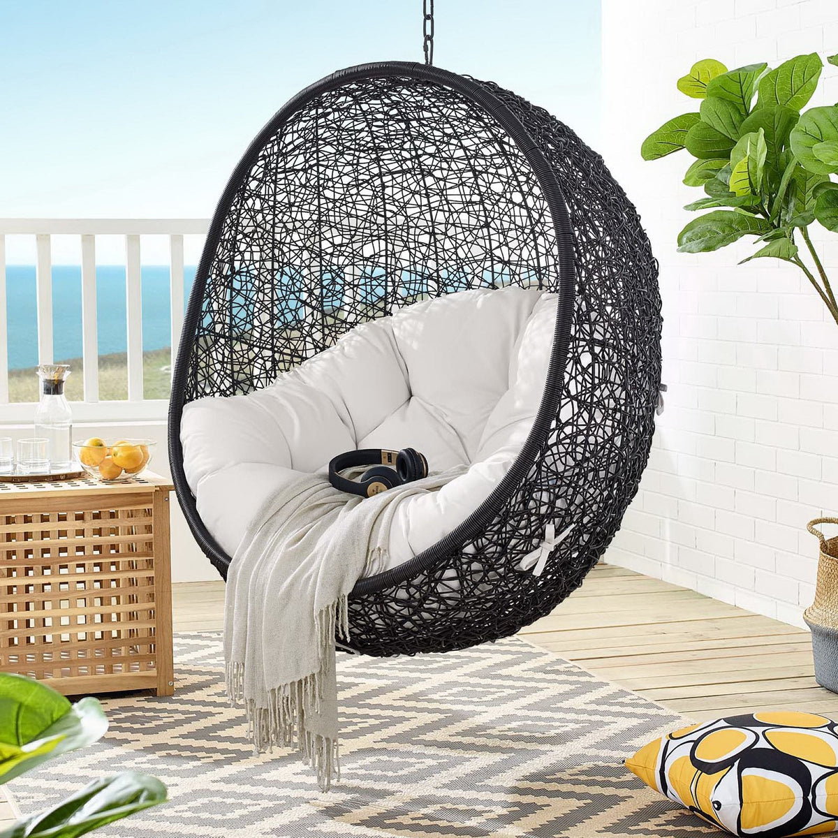 Encase Sunbrella Swing Outdoor Lounge Chair with gray cushions, hanging black woven rattan on Tampa Home & Garden Store