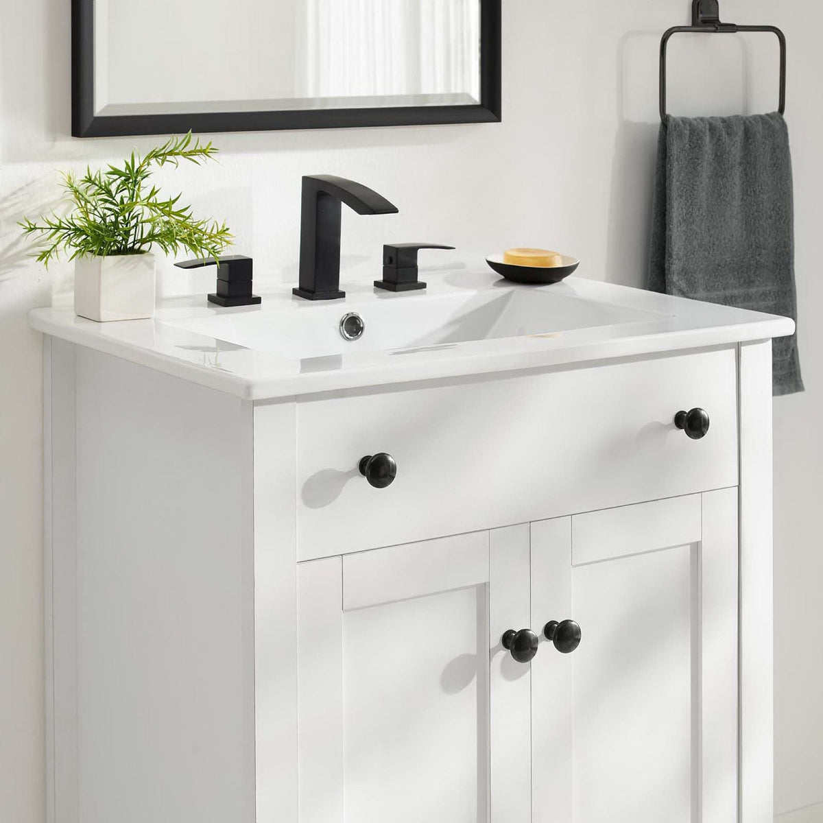 Nantucket 24in bathroom vanity cabinet white finish with black hardware and faucet on Tampa Home & Garden Store
