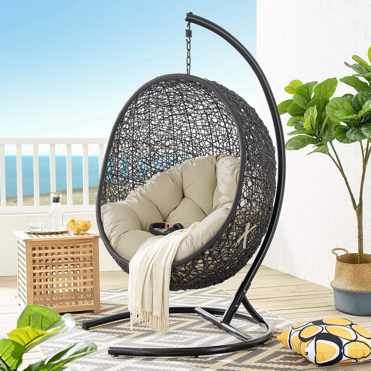 Encase Swing Patio Lounge Chair hanging chair with dark woven rattan and beige cushions on Tampa Home & Garden Store