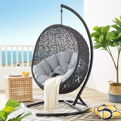 Encase Swing outdoor lounge chair with gray cushions in circular wicker on curved stand on Tampa Home & Garden Store