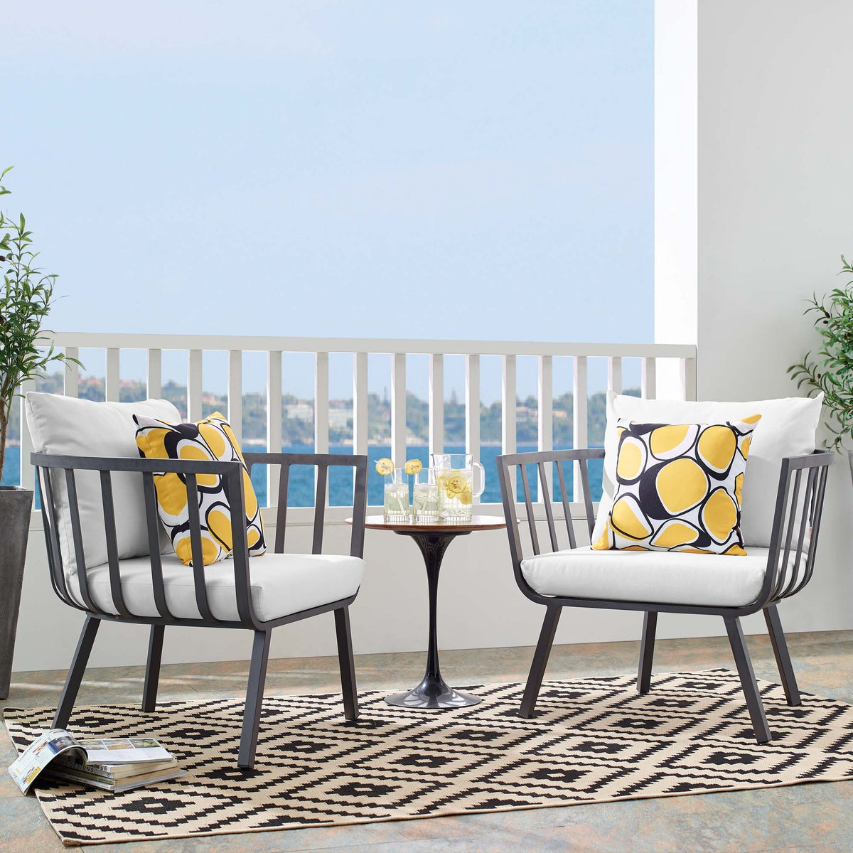Riverside outdoor aluminum armchairs set of 2 with white cushions and yellow geometric pillows by Modway on balcony on Tampa Home & Garden Store
