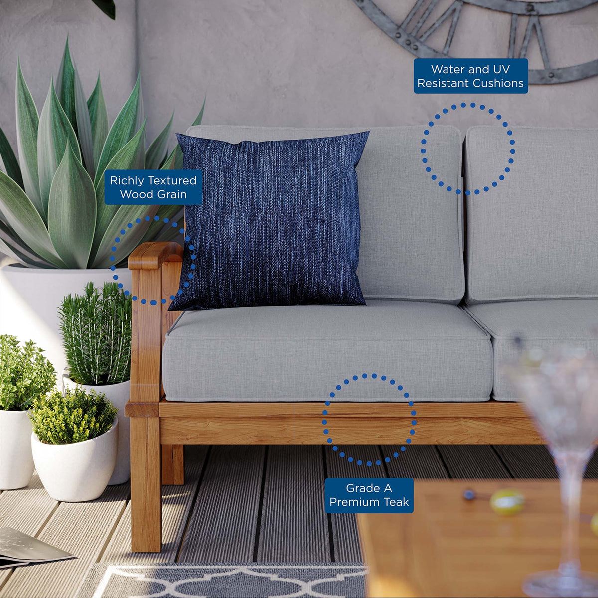 Marina outdoor teak sofa with grey cushions and rich wood grain frame on Tampa Home & Garden Store