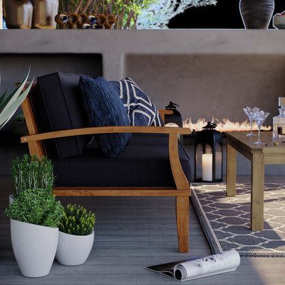 Marina Outdoor Teak Sofa with black cushions and blue pillows by HouseOfZazla on Tampa Home & Garden Store