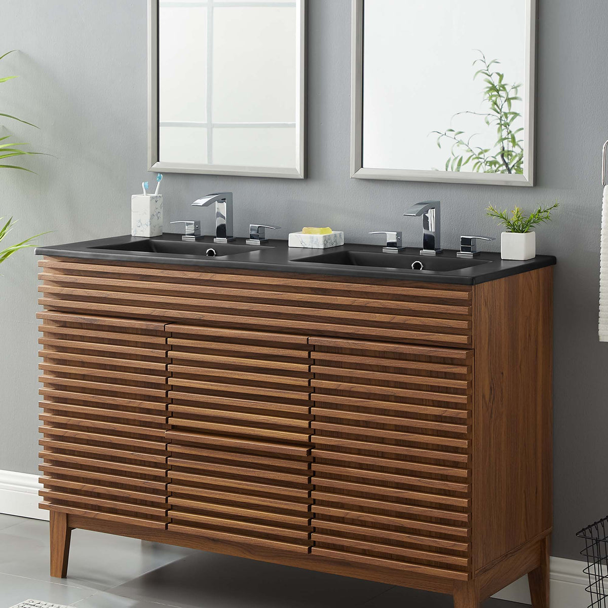 Cayman double-basin bathroom sink with chrome faucets on dark countertop and wood slatted vanity on Tampa Home & Garden Store