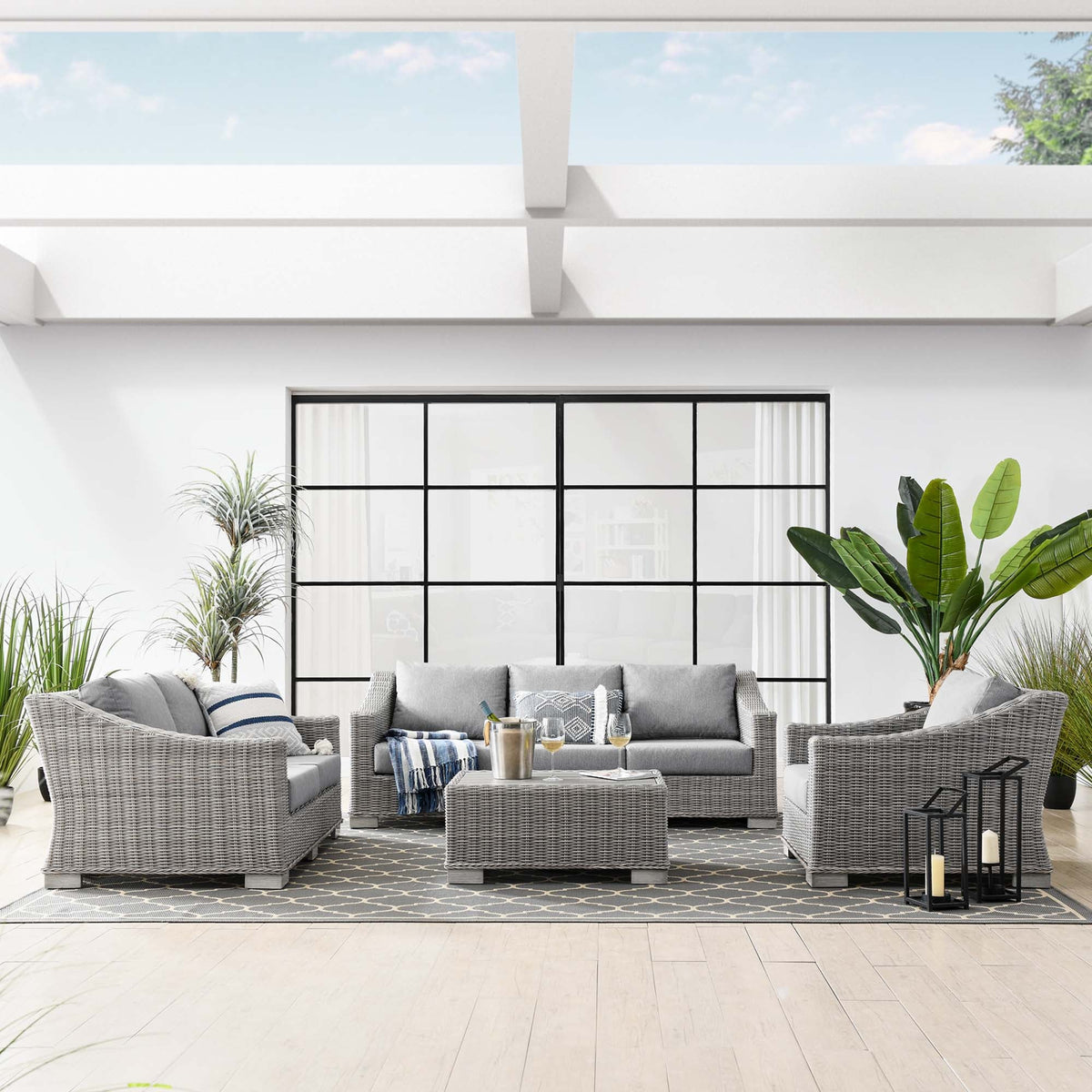 Conway 4-Piece outdoor wicker rattan furniture set with gray cushions on a white patio on Tampa Home & Garden Store