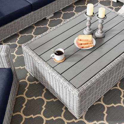 Conway 4-piece outdoor wicker set with gray rattan and navy cushions on a slatted table on Tampa Home & Garden Store
