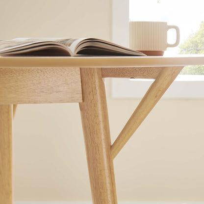 Gallant 47in round dining table by Modway; natural wood legs; open magazine and white ribbed mug on Tampa Home & Garden Store