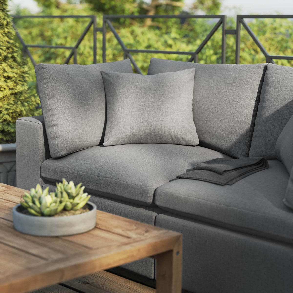 Commix Overstuffed Outdoor Patio Loveseat in gray fabric with cushions on deck on Tampa Home & Garden Store