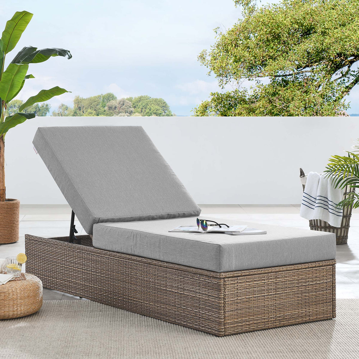Convene outdoor patio chaise lounge with gray cushions on a woven wicker base on Tampa Home & Garden Store