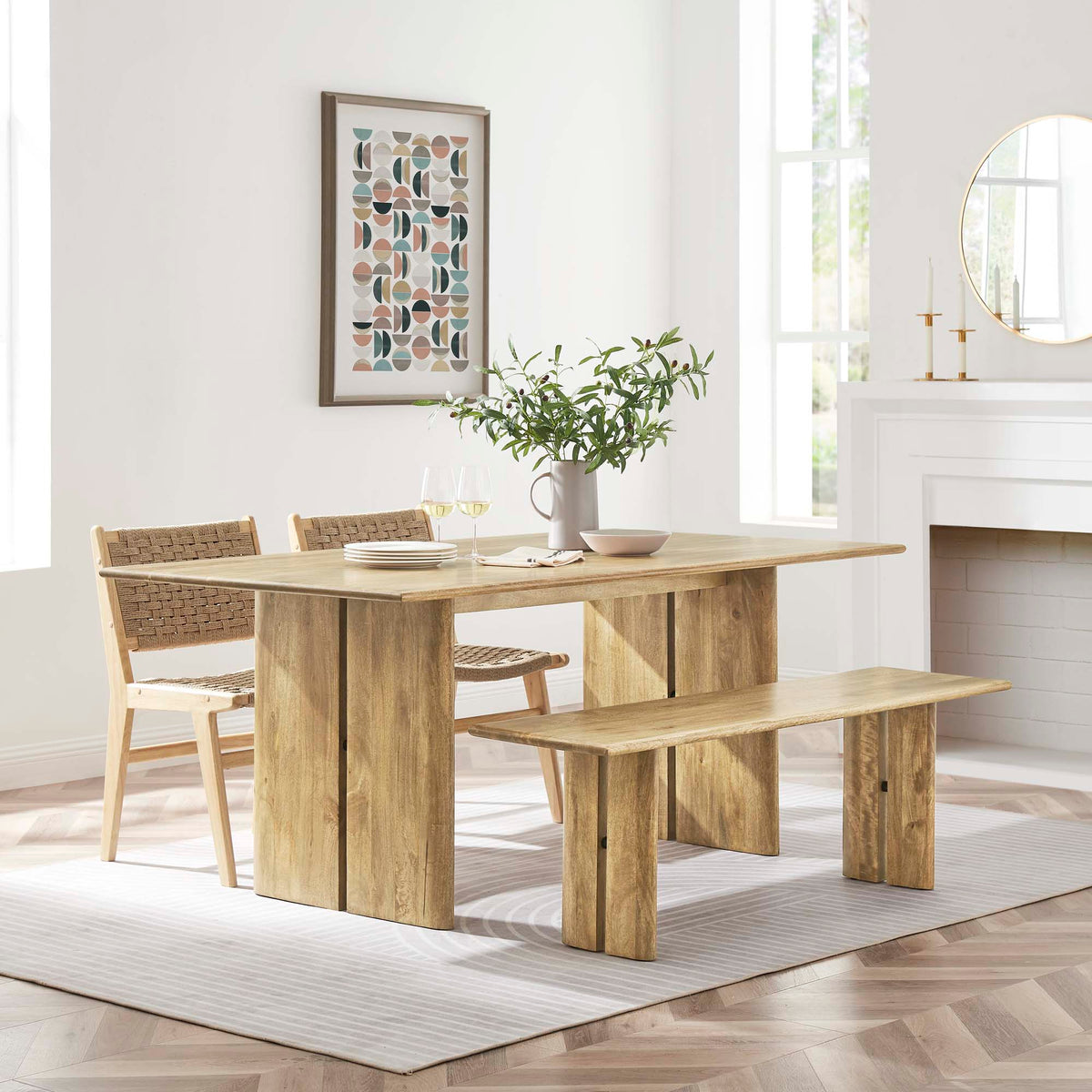 Amistad wood dining table with bench and woven chairs in natural oak finish bright dining room on Tampa Home & Garden Store
