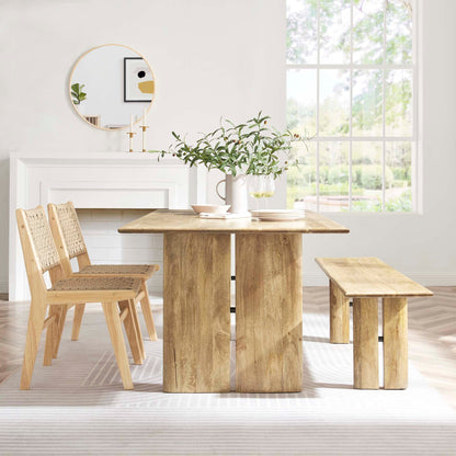 Amistad wood dining table with bench and woven chairs in natural oak finish in dining space on Tampa Home & Garden Store