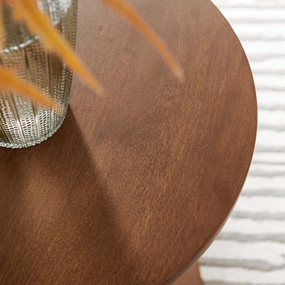 Lina Round Wood Side Table with warm brown finish and visible grain, shown with textured metal vase on Tampa Home & Garden Store