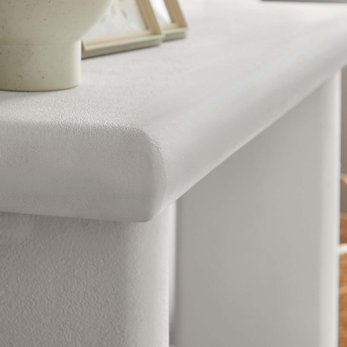 Relic Concrete Textured Console Table top in light gray speckled finish with vase and frames on Tampa Home & Garden Store