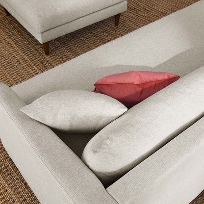 Zoya down-filled sofa and ottoman set in beige fabric with wooden legs and coral pillow on Tampa Home & Garden Store
