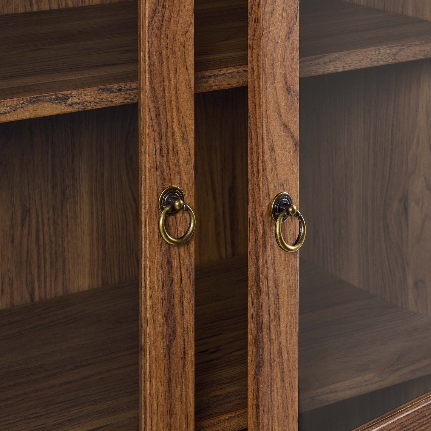 Tessa tall arched display cabinet in warm wood finish with brass ring pulls on Tampa Home & Garden Store