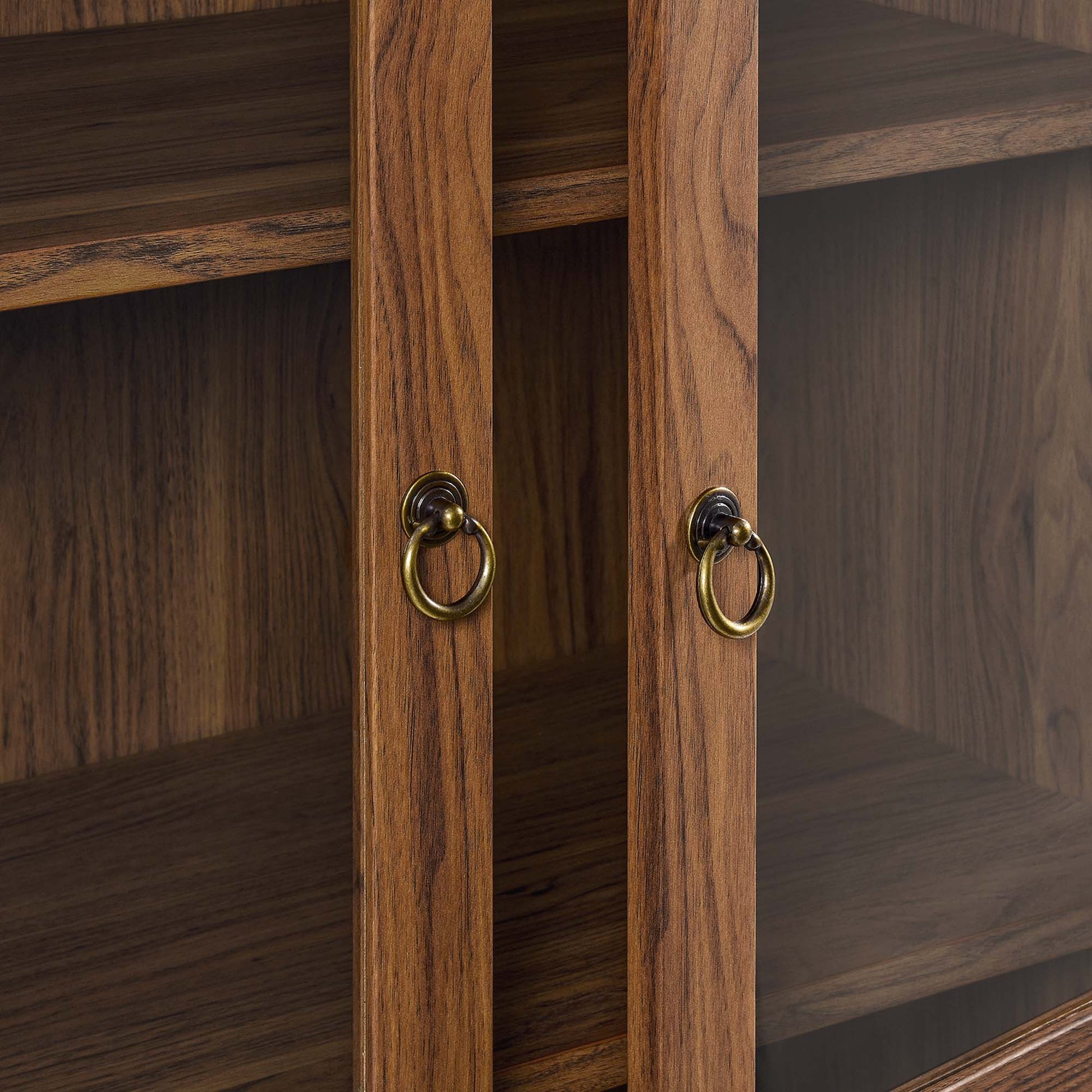 Tessa tall arched display cabinet in warm wood finish with brass ring pulls on Tampa Home & Garden Store