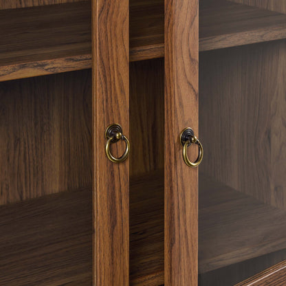 Tessa tall arched display cabinet in warm wood finish with brass ring pulls on Tampa Home & Garden Store