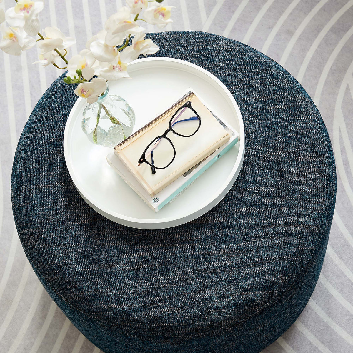 Callum large round woven heathered fabric upholstered ottoman in denim blue with white tray on Tampa Home & Garden Store