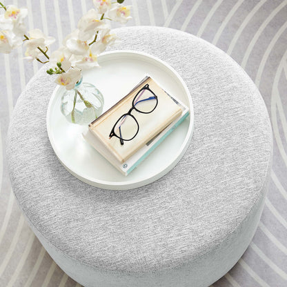 Callum round woven heathered gray fabric upholstered ottoman with white tray, vase and glasses on Tampa Home & Garden Store