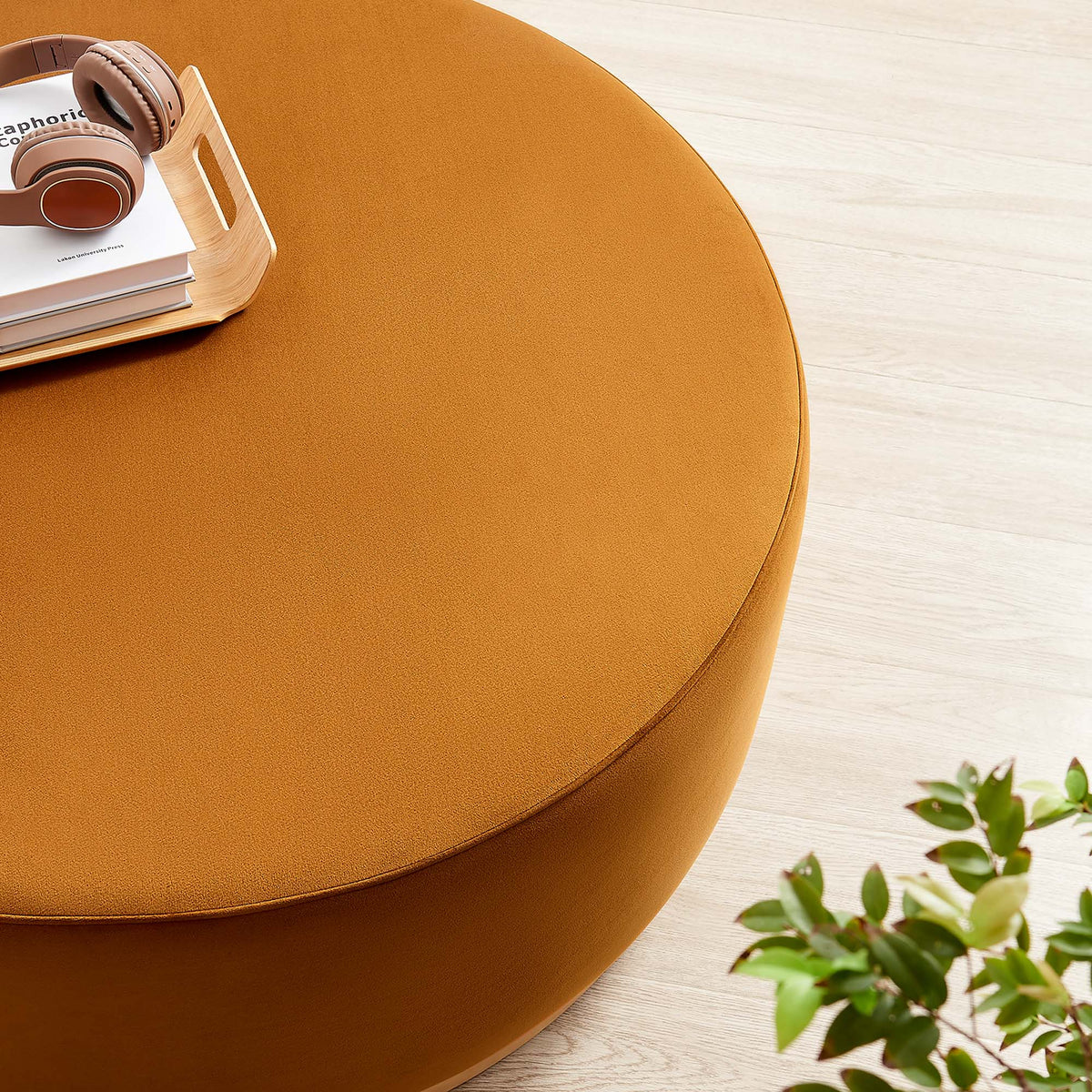 Tilden Large 38in Round Velvet Ottoman by Modway in orange with headphones on a wood table on Tampa Home & Garden Store