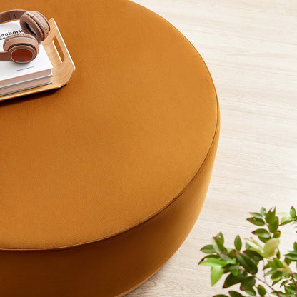 Tilden Large 38in Round Velvet Ottoman by Modway in orange with headphones on a wood table on Tampa Home & Garden Store