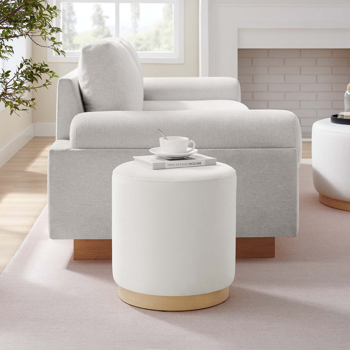 Two Tilden 16-inch round performance velvet ottomans in light gray with natural wood bases on Tampa Home & Garden Store