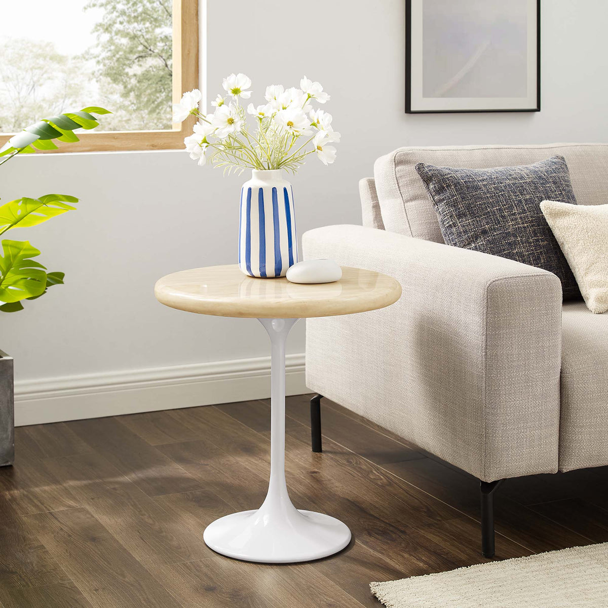 Lippa round faux travertine side table with white pedestal base in living room, beige top on Tampa Home & Garden Store