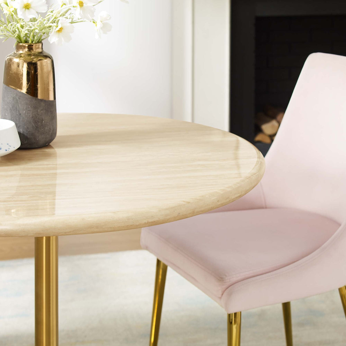 Lippa round faux travertine dining table with gold legs and pink chairs, vase with white flowers on Tampa Home & Garden Store