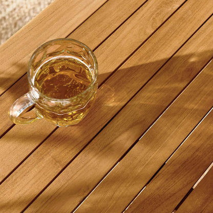 Vienna 34in square outdoor teak dining table with glass of beer on top on Tampa Home & Garden Store