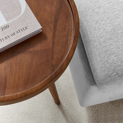 Chiro Round Wood Side Table warm brown finish with curved edge beside a grey sofa on Tampa Home & Garden Store