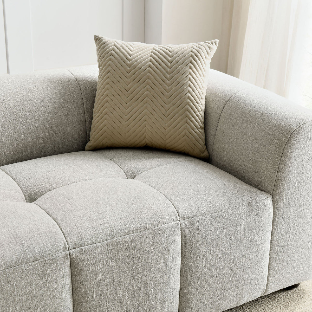 Liana upholstered fabric sofa with beige chevron pillow on light gray textured fabric on Tampa Home & Garden Store